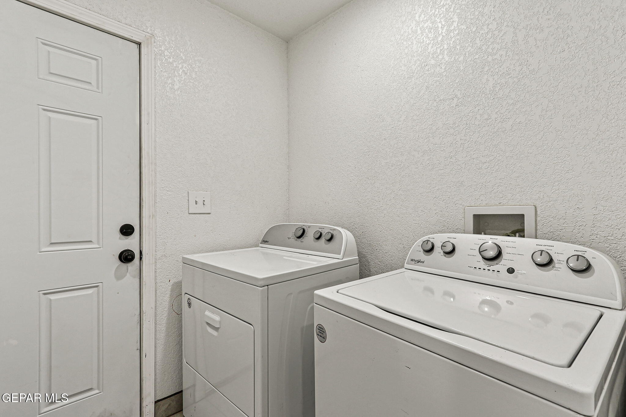 13419 Mendoza Road San Elizario, TX 79849 - Photo 32 of 55 a view of washer and dryer with bathroom in the background
