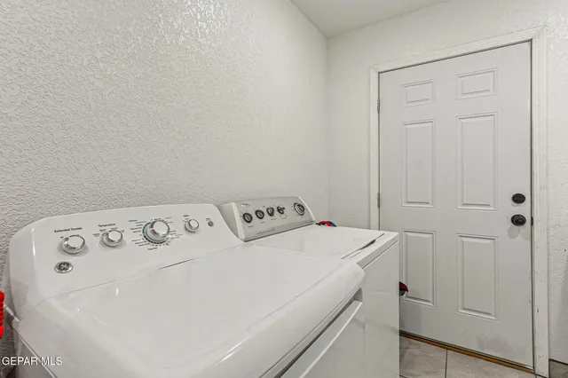 a living room with furniture a rug and a chandelier