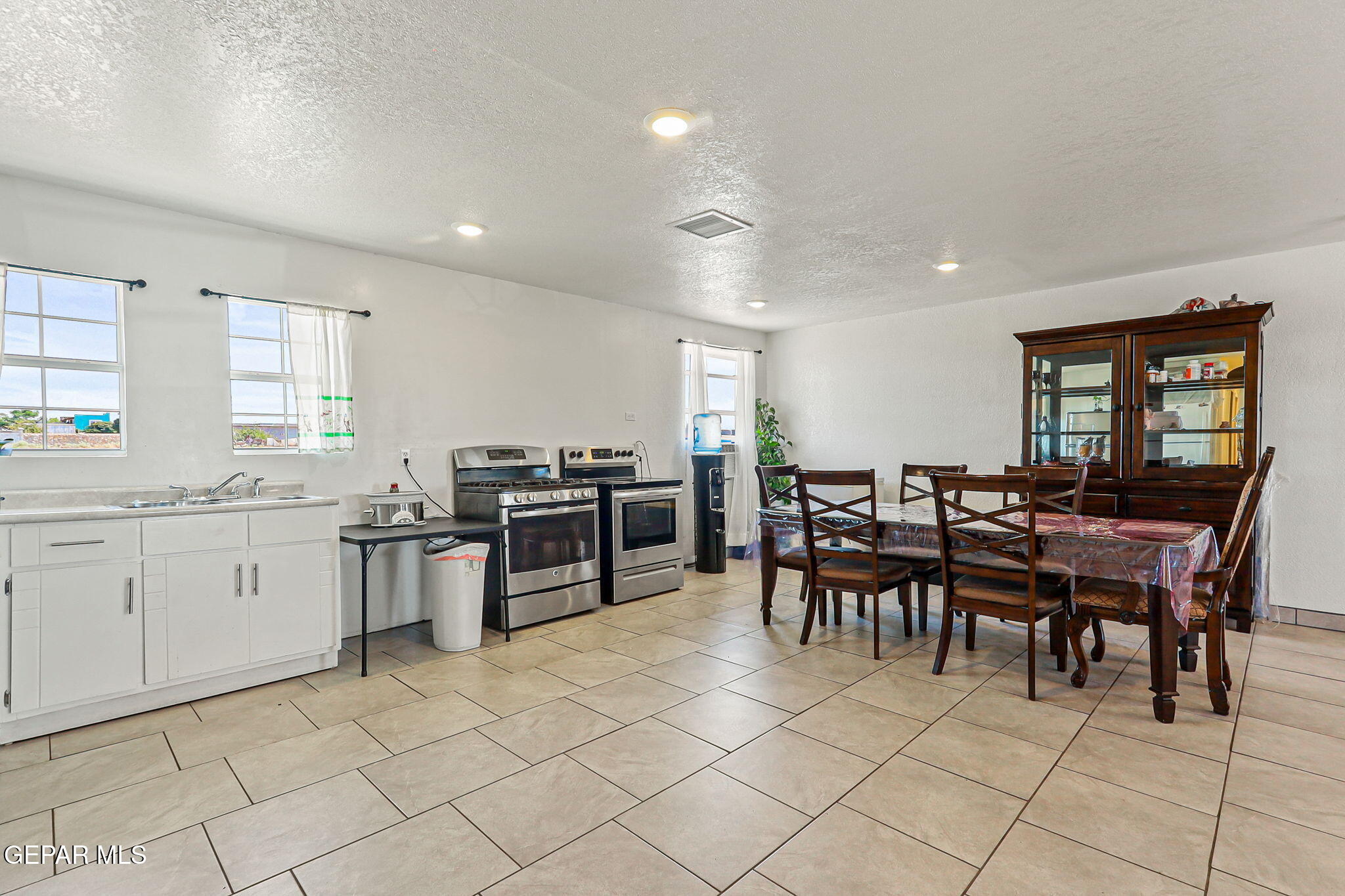 13419 Mendoza Road San Elizario, TX 79849 - Photo 10 of 55 a kitchen with sink and chairs