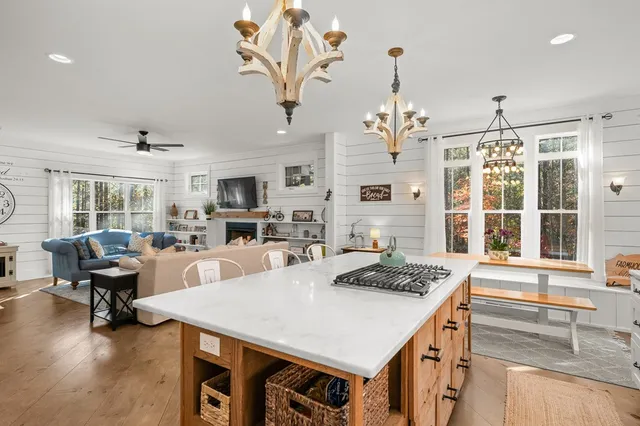 a living room with furniture and a chandelier