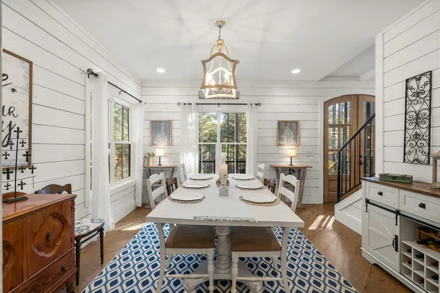 a room with pool table and windows