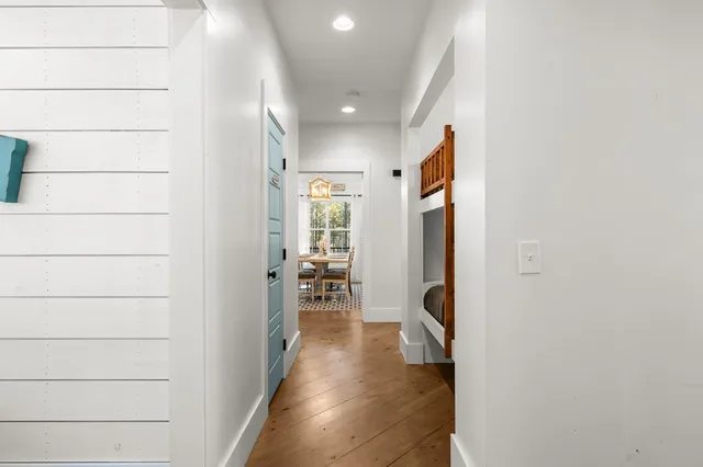 a view of a porch with furniture and wooden floor