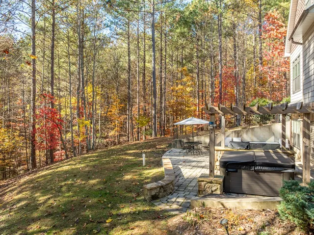 a view of patio with chairs and tables under an umbrella
