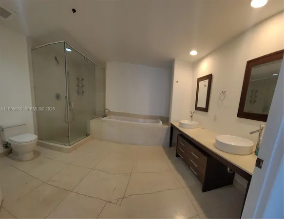 a bathroom with a double vanity sink toilet and shower