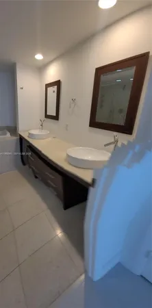 a bathroom with a double vanity sink and mirror