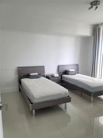 a bedroom with a bed and a night stand