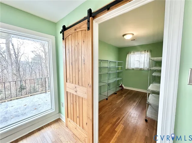 a kitchen with a sink and wooden floor
