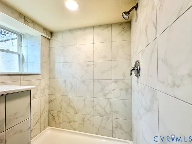 a bathroom with a sink vanity mirror and toilet