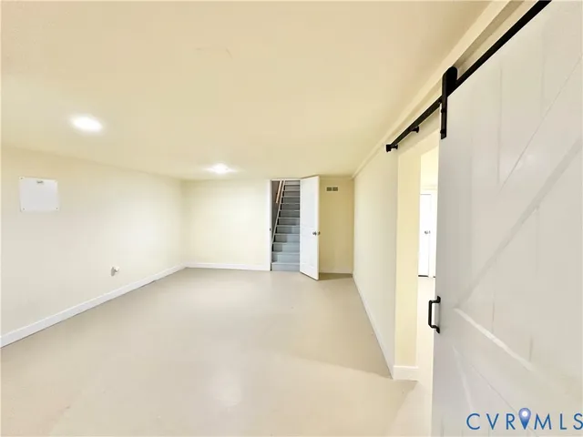 a kitchen with stainless steel appliances granite countertop a stove a sink and a refrigerator with white cabinets