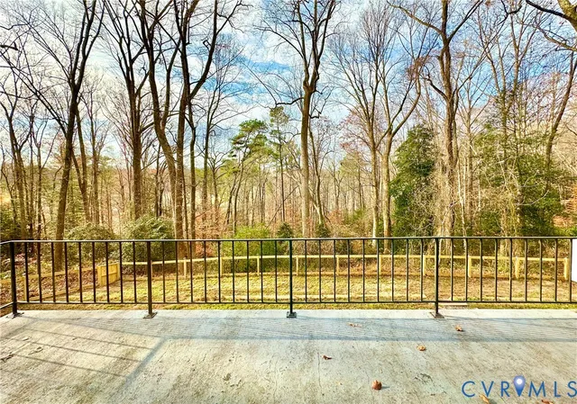 a kitchen with a refrigerator and white cabinets