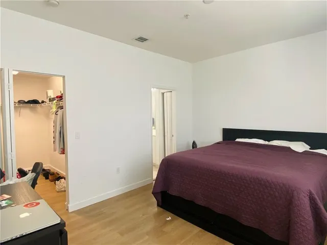 a bedroom with a bed and a dresser