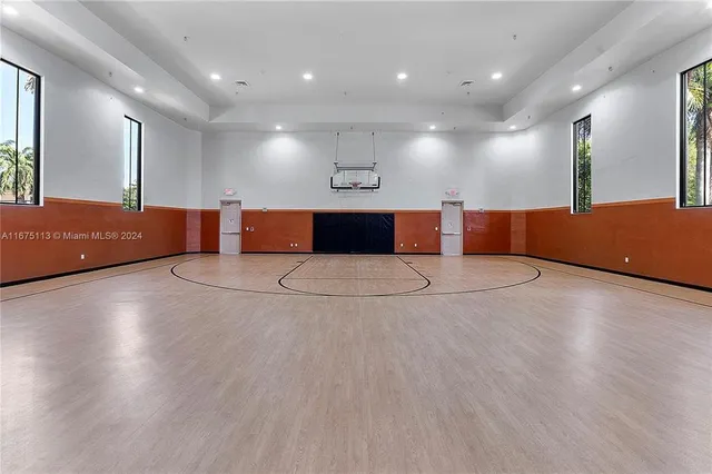 a kitchen with stainless steel appliances wooden cabinets and wooden floor