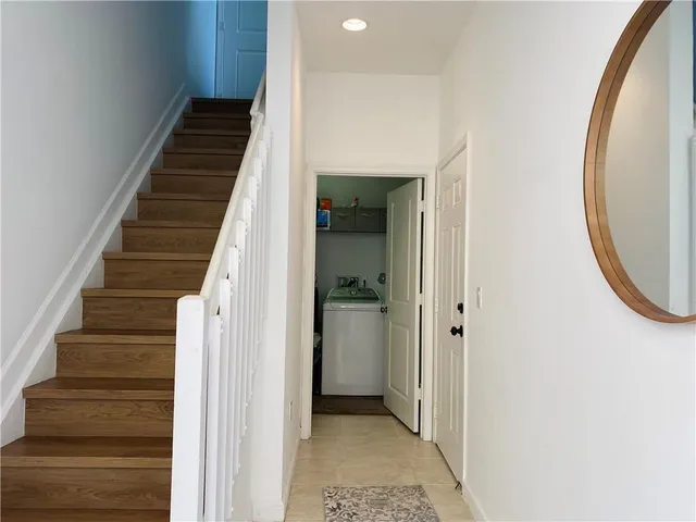 a view of a hallway with wooden floor and entryway