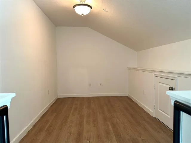 a view of a room with wooden floor