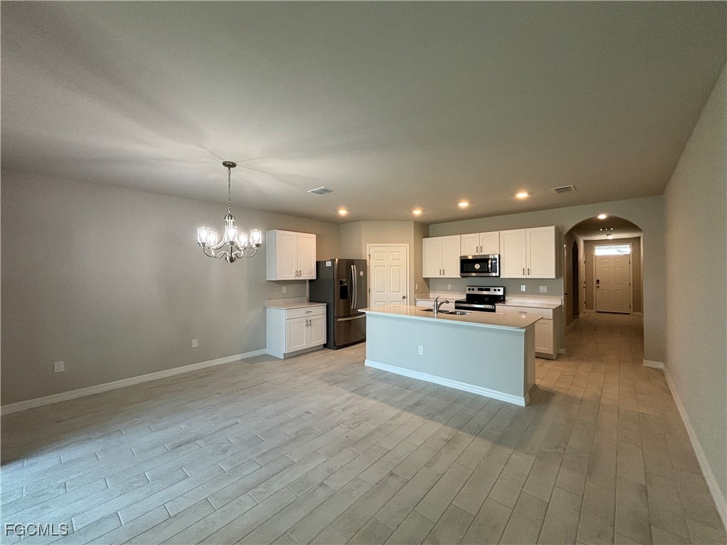 20461 Camino Torcido Loop North Fort Myers, FL 33917 - Photo 10 of 17 a large open kitchen with a refrigerator a stove top oven and a sink
