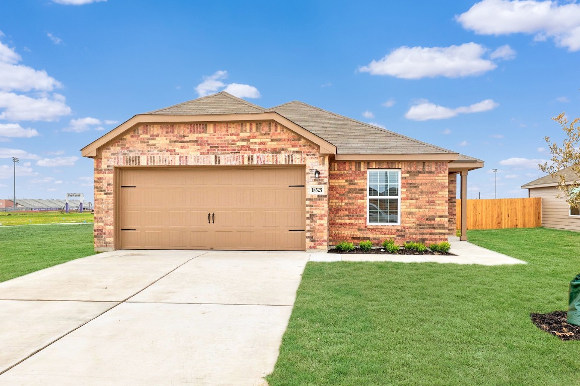 a front view of a house with a garden and plants