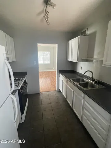 a kitchen that has a sink and a stove