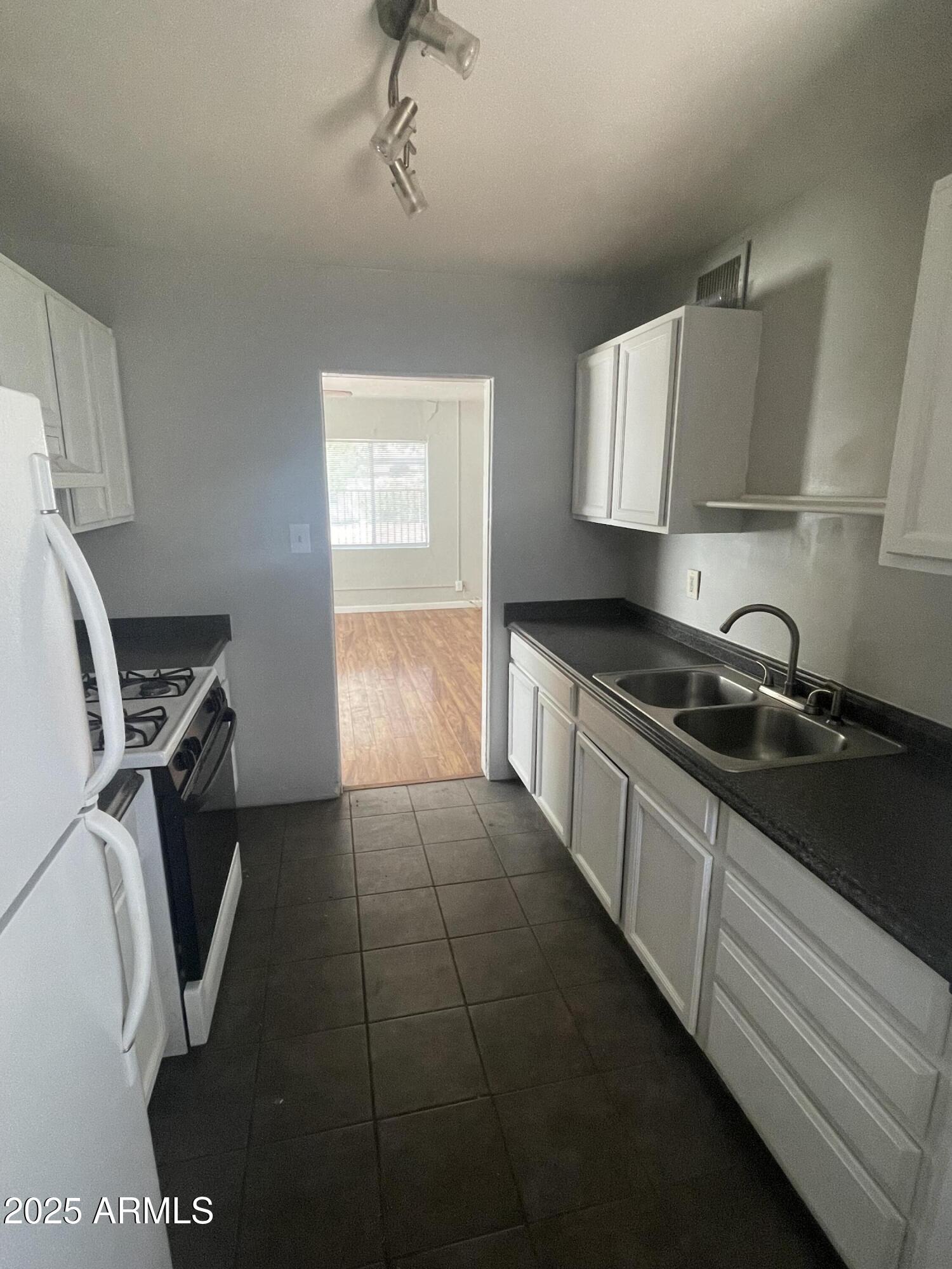 1226 West Roosevelt Street Phoenix, AZ 85007 - Photo 6 of 11 a kitchen that has a sink and a stove
