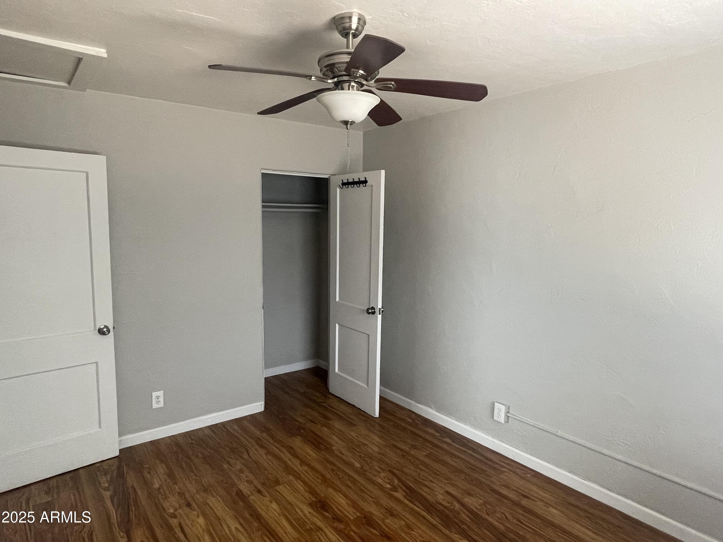 1226 West Roosevelt Street Phoenix, AZ 85007 - Photo 8 of 11 a view of an empty room with wooden floor
