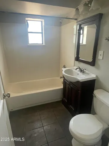 a bathroom with a toilet a sink and bathtub