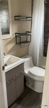 a bathroom with a toilet and a sink