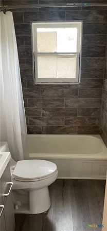 a bathroom with a toilet and a bathtub
