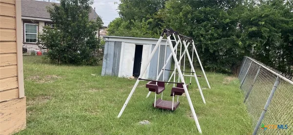a view of a small yard with a small deck
