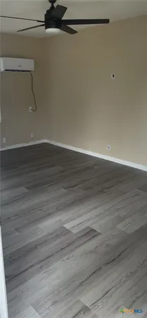 a view of a room with wooden floor