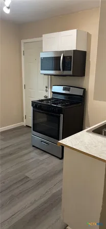 a kitchen with a stove and a microwave