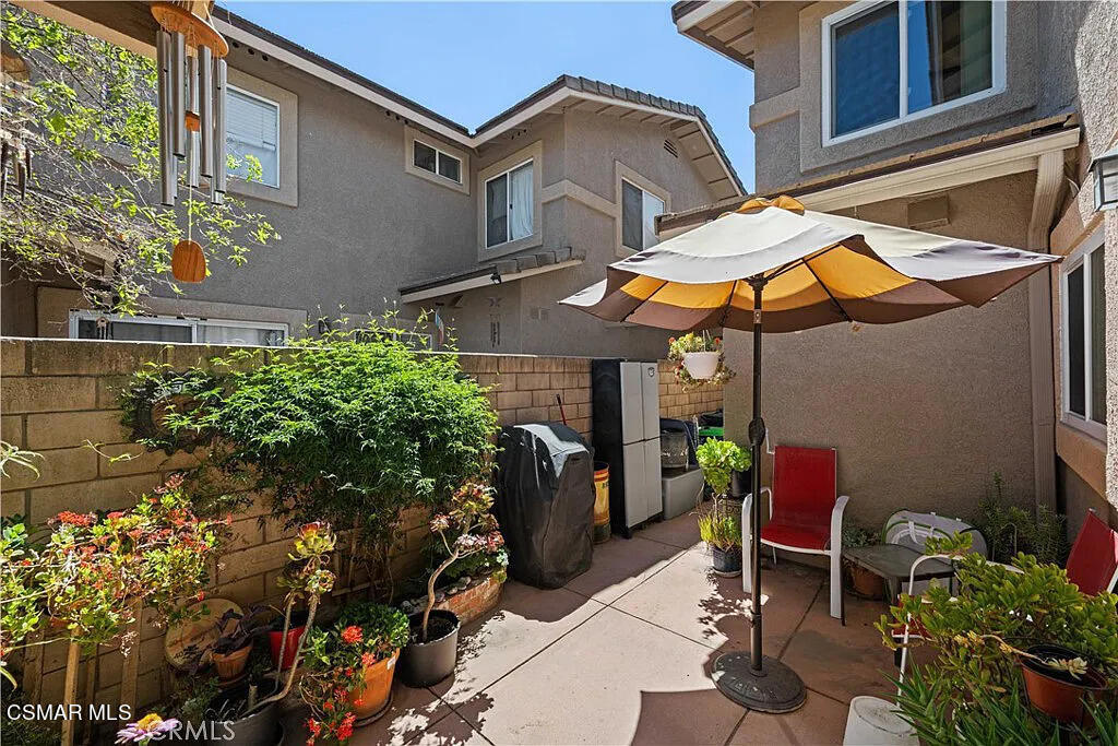 4492 Apricot Road, Unit B Simi Valley, CA 93063 - Photo 11 of 24 a view of a patio with a table and chairs under an umbrella