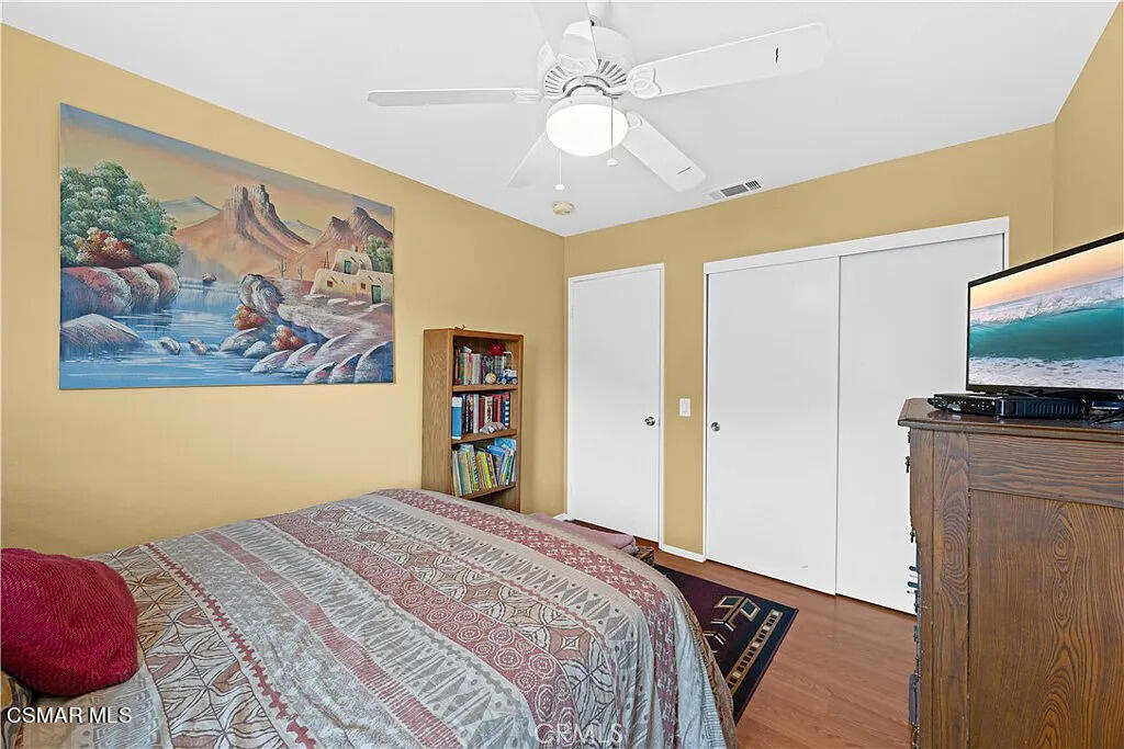 4492 Apricot Road, Unit B Simi Valley, CA 93063 - Photo 15 of 24 a bedroom with a large bed a flat tv screen and a dresser