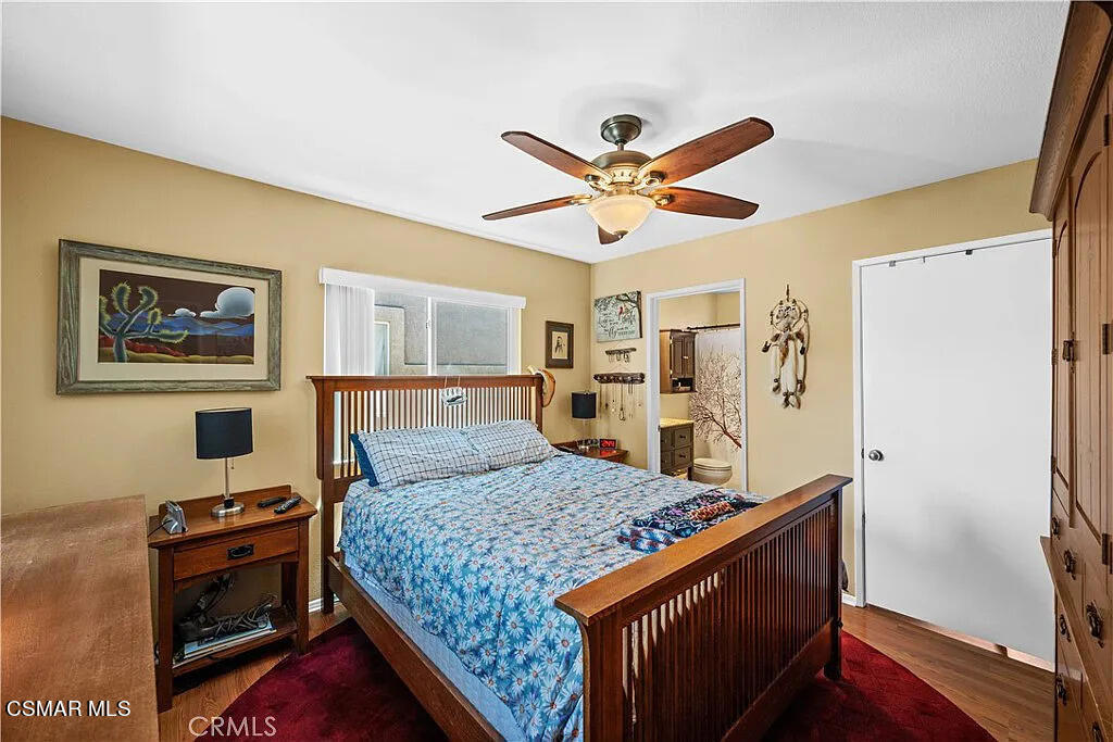 4492 Apricot Road, Unit B Simi Valley, CA 93063 - Photo 19 of 24 a bedroom with a bed and a chandelier