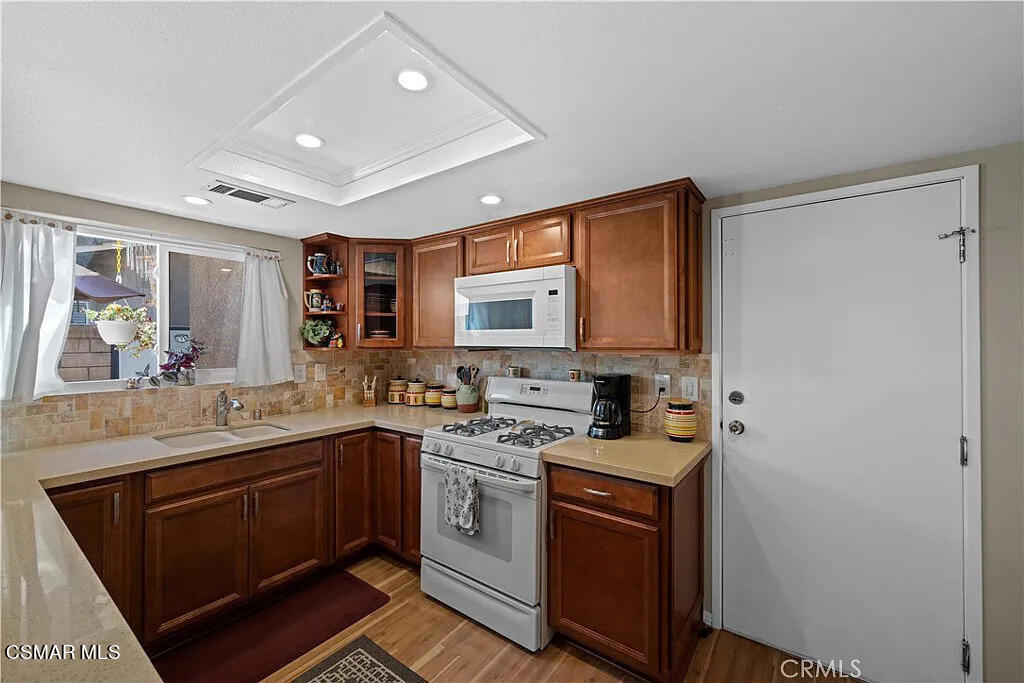 4492 Apricot Road, Unit B Simi Valley, CA 93063 - Photo 8 of 24 a kitchen with a sink stove and cabinets