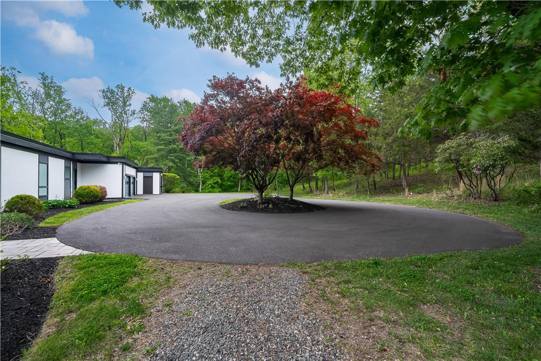 1506 Pleasant View Road Coopersburg, PA 18036 - Photo 8 of 97 A gracefully curved driveway guides the way to a private, contemporary residence nestled among lush trees.