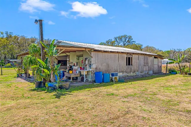 a kitchen with a sink dining table and chairs