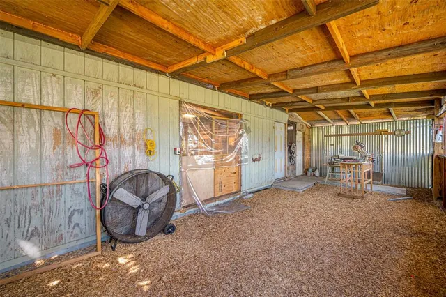 a dining room with wooden floor a chandelier a wooden table and chairs