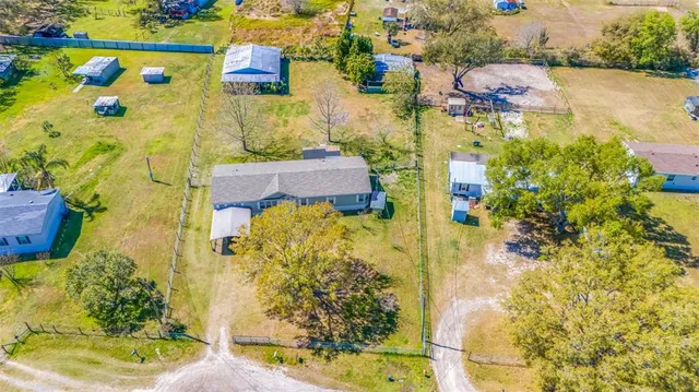 a view of a big yard with large trees