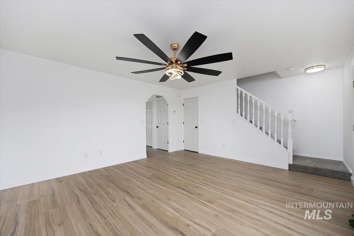 1897 Hampton Way Twin Falls, ID 83301 - Photo 17 of 48 Unfurnished living room featuring light wood finished floors and ceiling fan