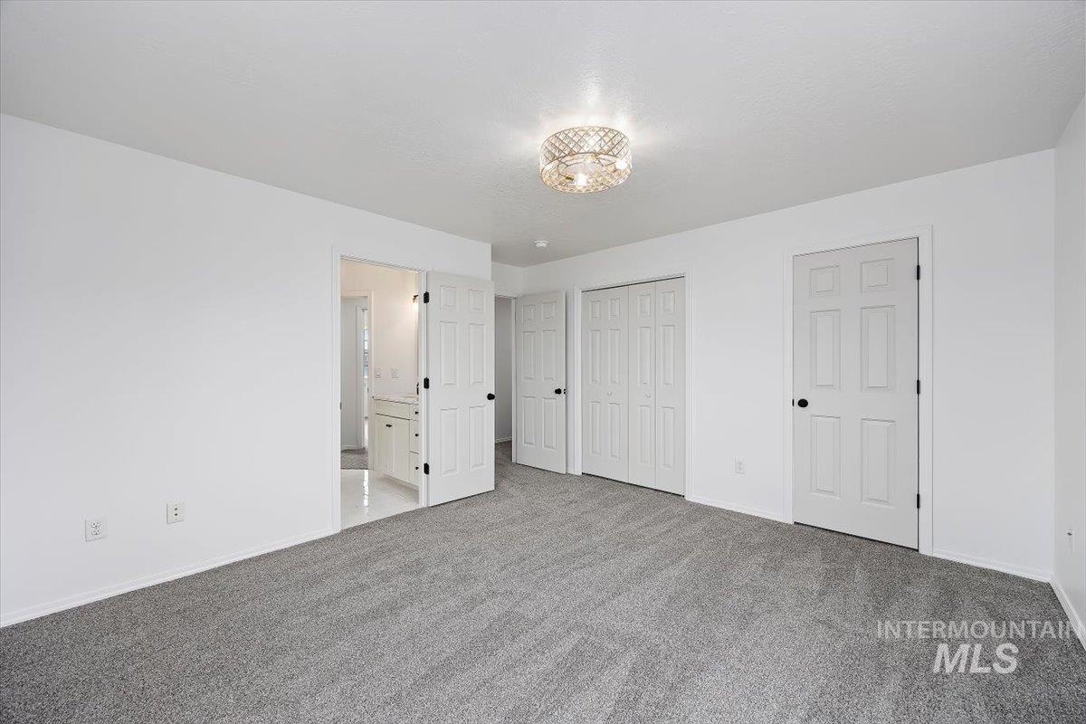 1897 Hampton Way Twin Falls, ID 83301 - Photo 19 of 48 Unfurnished bedroom featuring ensuite bathroom, carpet flooring, and a closet