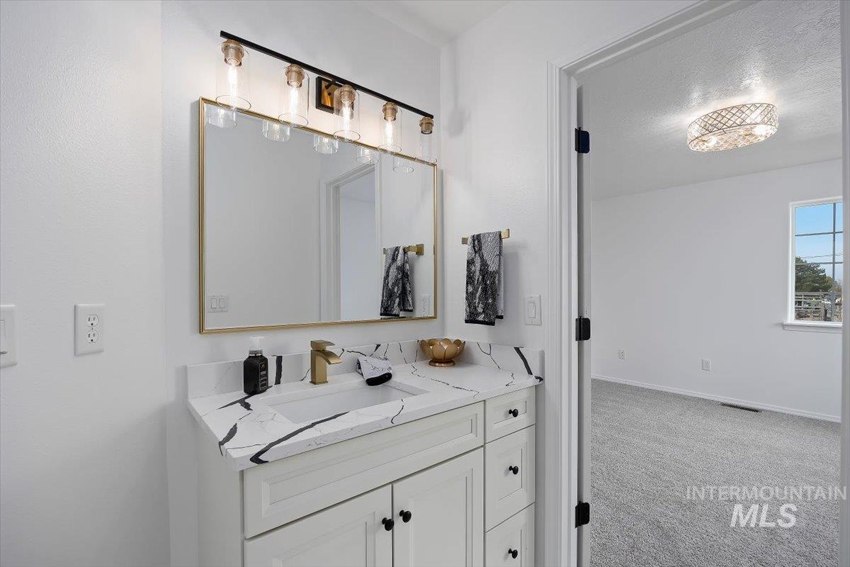 1897 Hampton Way Twin Falls, ID 83301 - Photo 23 of 48 Bathroom featuring vanity and light colored carpet