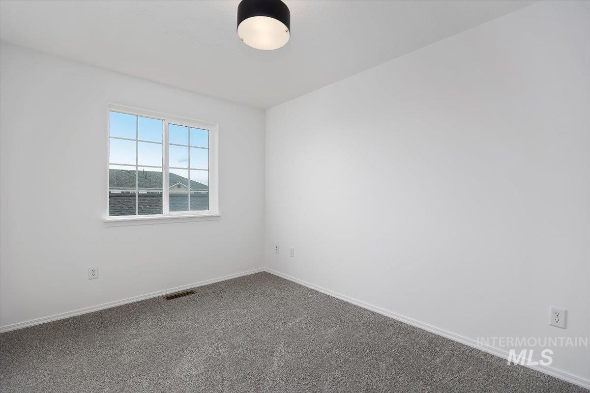 1897 Hampton Way Twin Falls, ID 83301 - Photo 25 of 48 Unfurnished room with baseboards and dark carpet