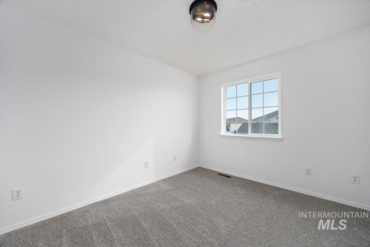 1897 Hampton Way Twin Falls, ID 83301 - Photo 27 of 48 Spare room with baseboards and dark carpet