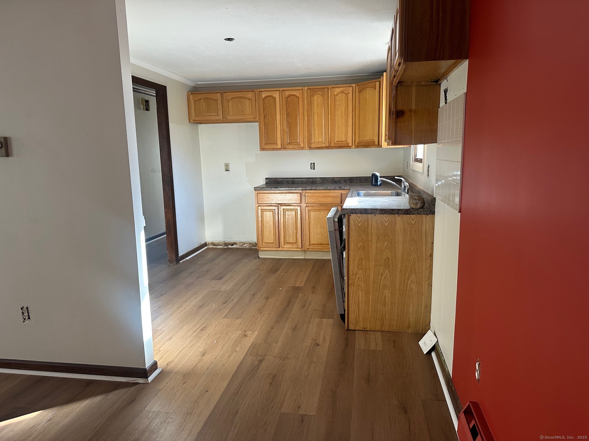 60 Coolidge Street Hartford, CT 06106 - Photo 6 of 13 a kitchen with a refrigerator a stove top oven and wooden floor