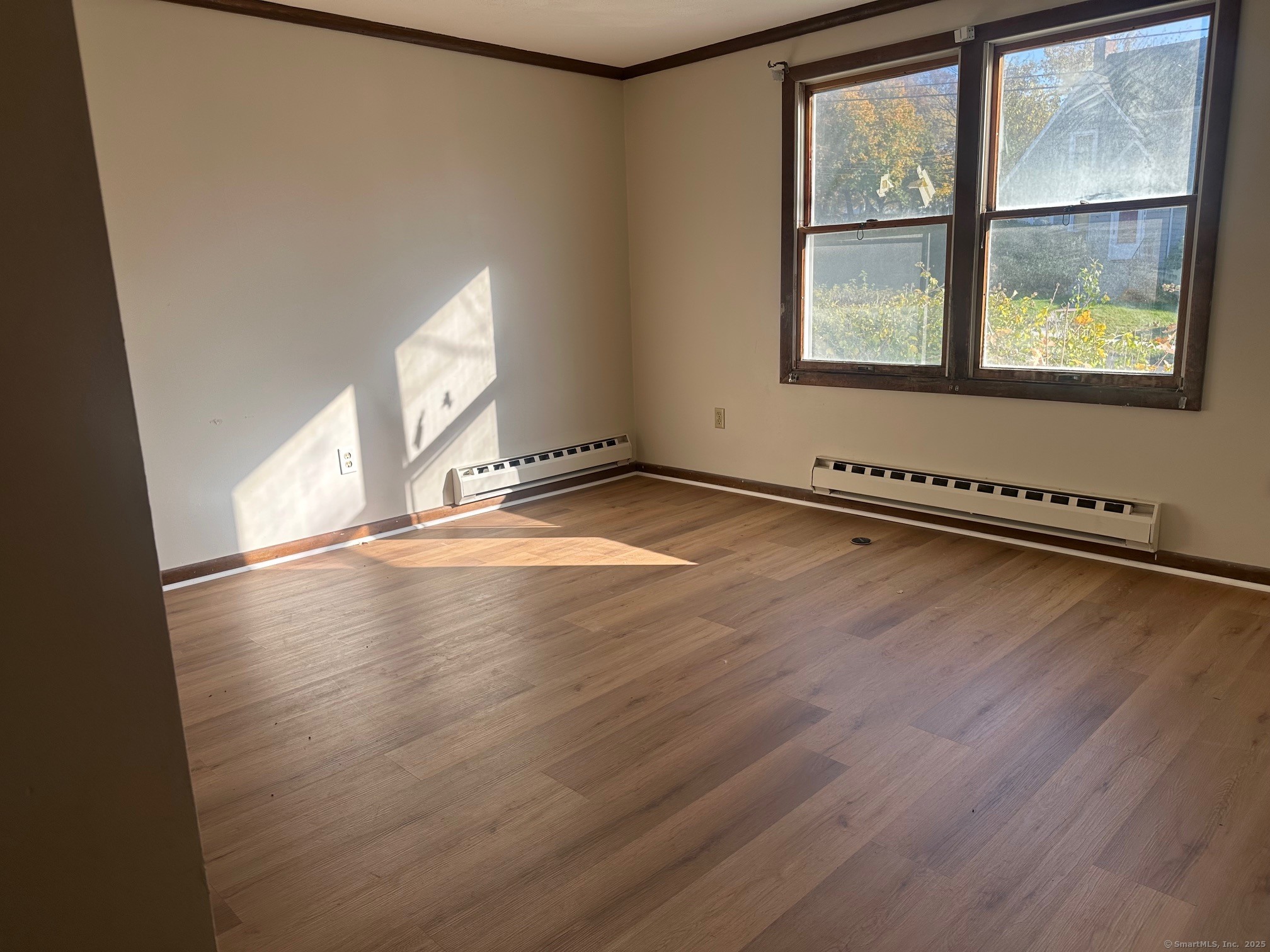 60 Coolidge Street Hartford, CT 06106 - Photo 10 of 13 an empty room with wooden floor and windows