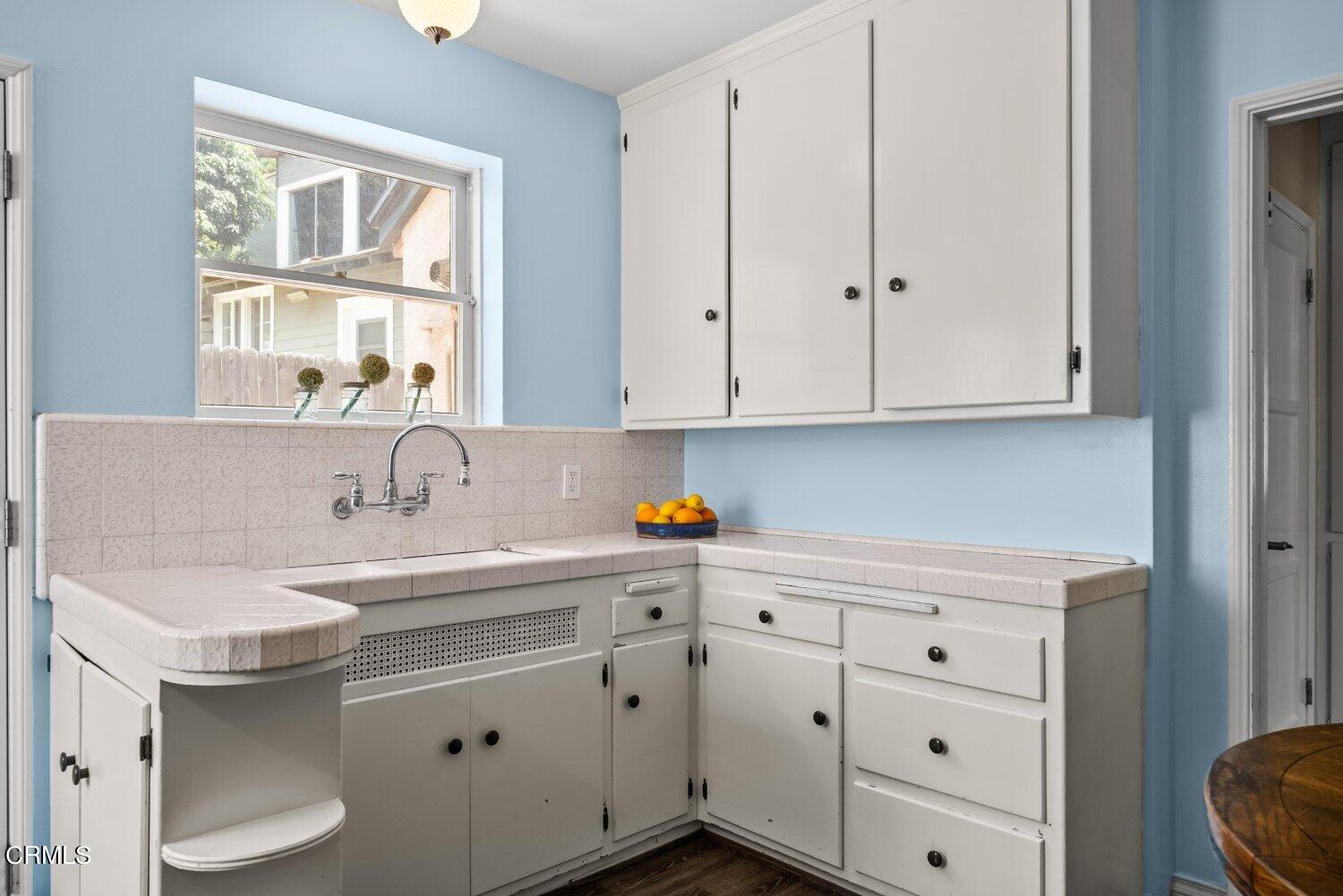 1807 Alpha Road Glendale, CA 91208 - Photo 14 of 26 a kitchen with granite countertop white cabinets and sink