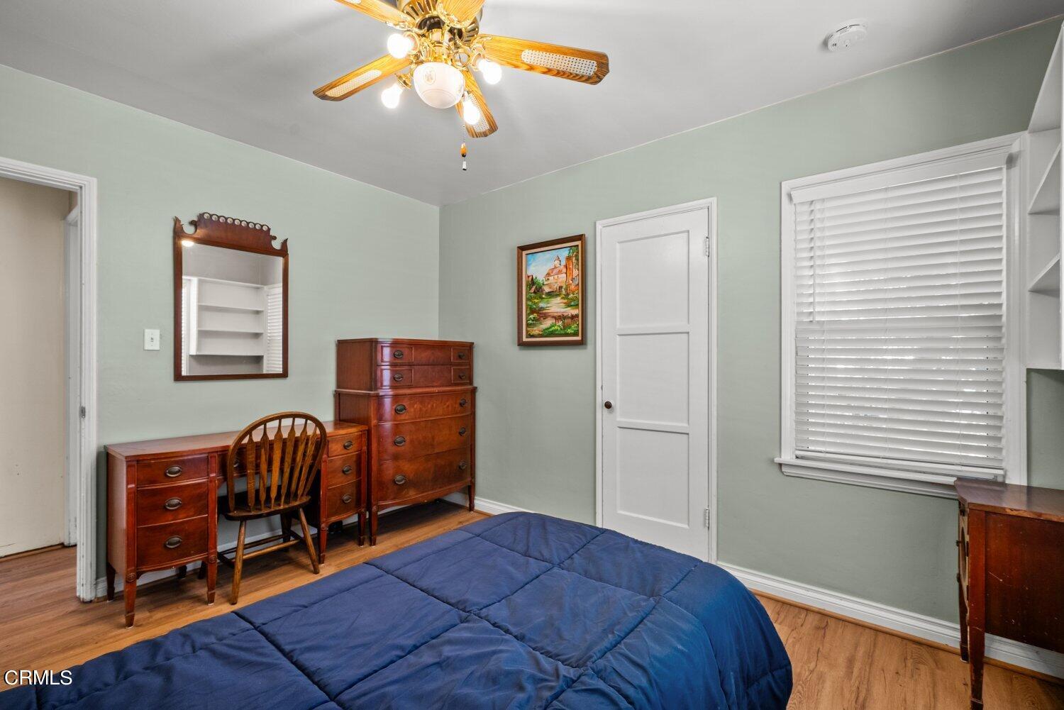 1807 Alpha Road Glendale, CA 91208 - Photo 9 of 26 a bedroom with a bed and a chandelier