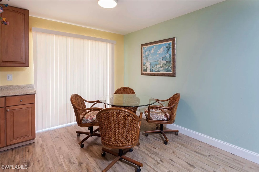 11093 Kelly Road Fort Myers, FL 33908 - Photo 4 of 12 a work room with furniture and wooden floor