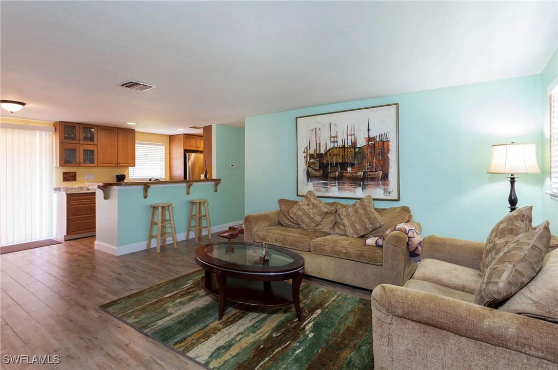 11093 Kelly Road Fort Myers, FL 33908 - Photo 6 of 12 a living room with furniture and a wooden floor