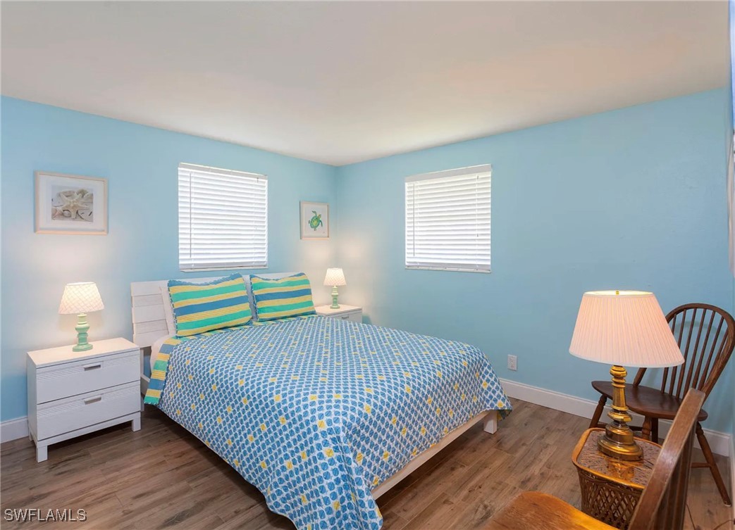 11093 Kelly Road Fort Myers, FL 33908 - Photo 9 of 12 a bedroom with a bed and a lamp on dresser