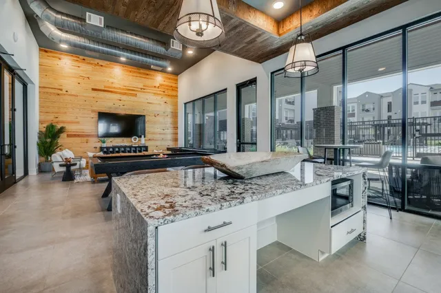 a bathroom with a granite countertop sink a toilet and a large mirror